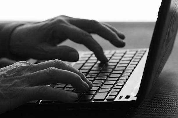 istock old woman typing on a laptop 637042354