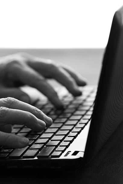 istock old woman typing on a laptop 637042402