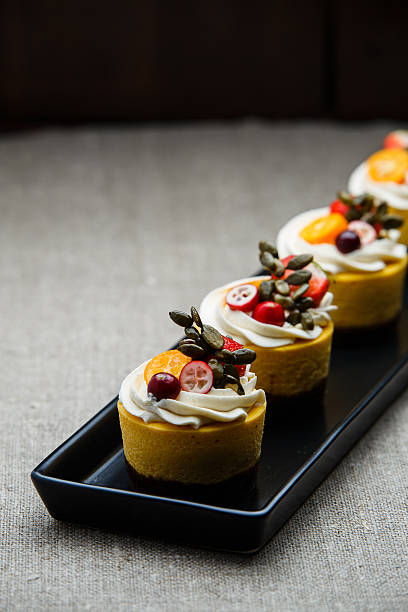 istock Delicious pumpkin cupcakes on black dish. 637043446