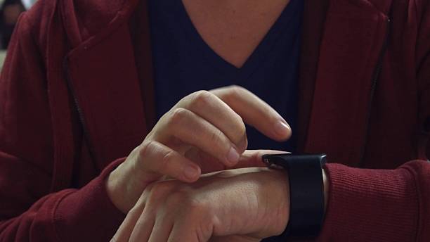 istock Man in red taps on his smartwatch. Modern wearable device 637043472