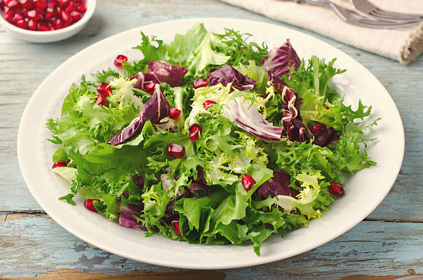 istock Green salad with spinach, frisee, arugula, radicchio and pomegranate seeds 637043552