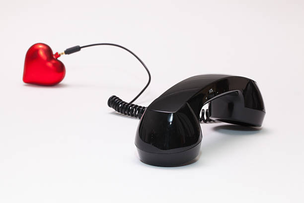 istock Old phone reciever and cord connection with red heart. 637043642