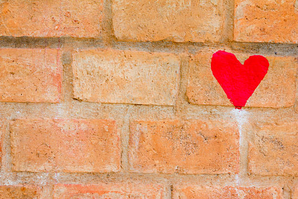 istock Red heart draw on brown brick wall background 637043808