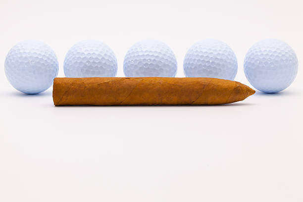istock Luxury Cuban cigar and white golf balls 637043966