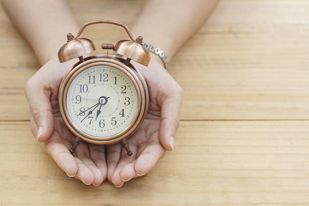 istock alarm clock on hand and  copy space for word 637044592
