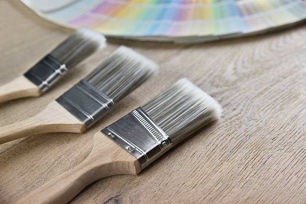 istock Paint brush and palette color on wood background 637044800