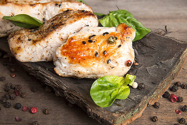 istock Grilled turkey fillet with appetizing roasted crust garnish spin 637045802