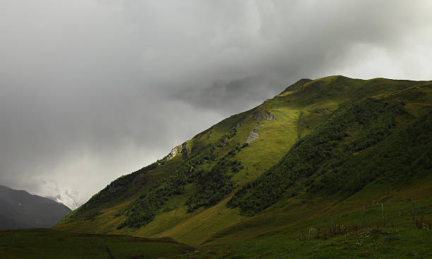 istock Image of green highland landscape with grey clouds 637046694