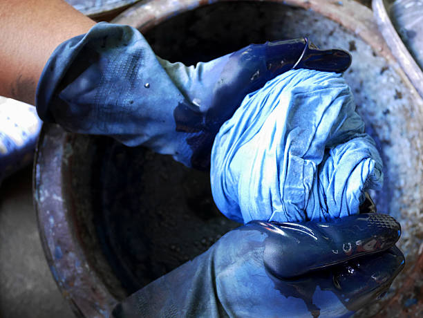 Thai men tie batik dyeing Indigenous Knowledge of Phrae people is Chemical and liquid dye Mauhom color in pot of Traditional clothes Kind of fashion in Northern Thailand  at Nonthaburi, Thailand.