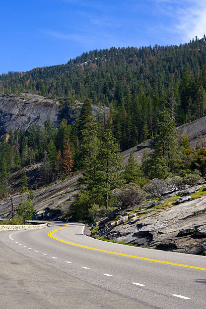 istock Curve road with rocks and mountain at the background. 637047910