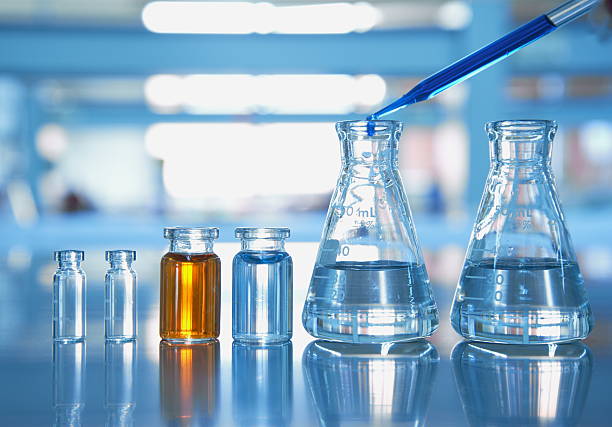 istock flask vial with orange and drop blue in science laboratory 637051778