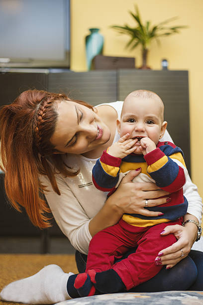 istock Happy mother playing with baby son 637052642