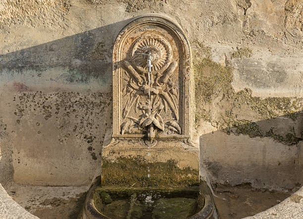 istock ancient water fountain  pipes carved in stone 637055424
