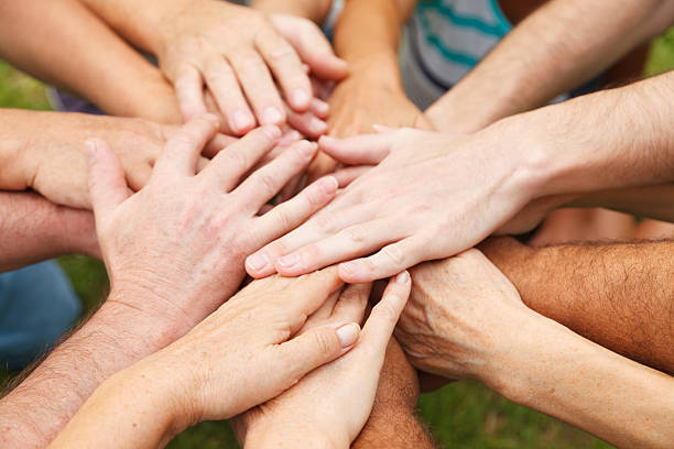 mains montrant l'unité - holding hands human hand holding multi ethnic group photos et images de collection