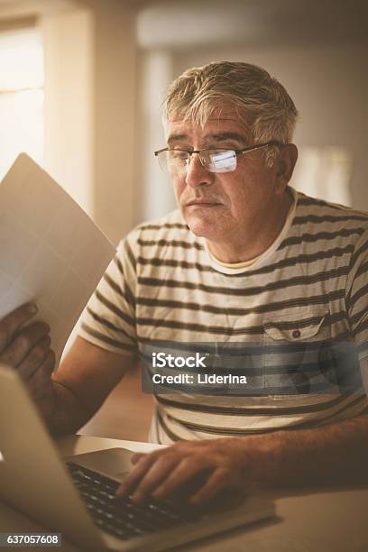Senior Man Paying Bills Online On Laptop Stock Photo - Download Image Now - 60-64 Years, 65-69 Years, Active Seniors