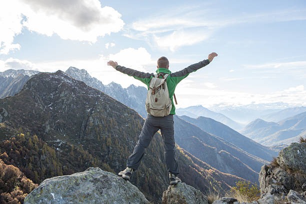 istock Hiker celebrates success on mountain top 637058788