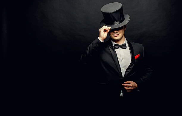 istock magician in a black suit holding 637060678