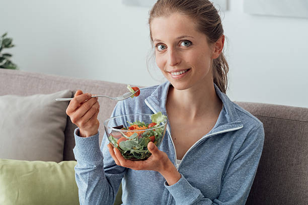 istock Young woman having lunch at home 637060694