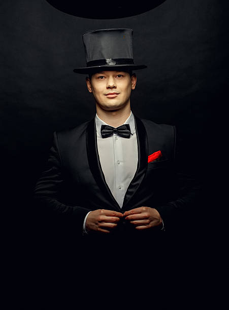 istock magician in a black suit holding 637060788