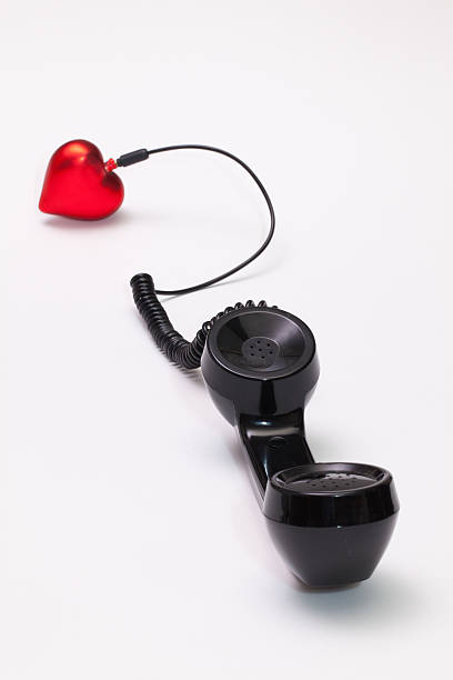 istock Old phone reciever and cord connection with red heart. 637062090
