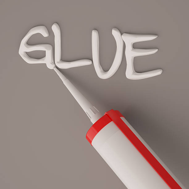 istock Visualization of silicone glue gun isolated on dark background 637062144