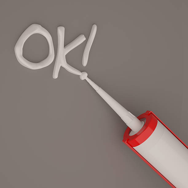 istock Visualization of silicone glue gun isolated on dark background 637062162