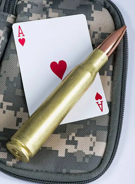 Photo of Ace of hearts and bullets.