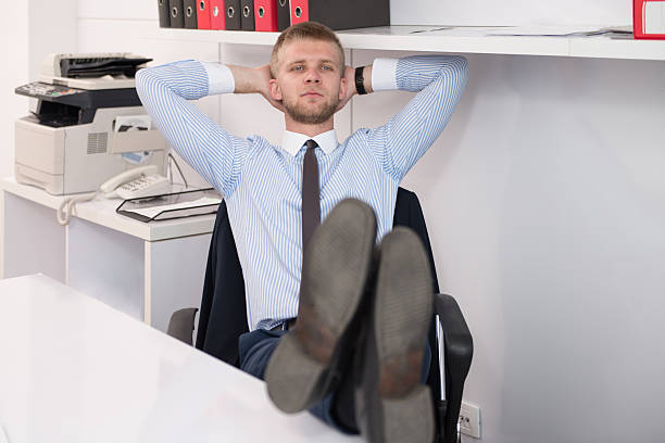 istock Young Businessman Relaxes Sitting In The Office 637066062