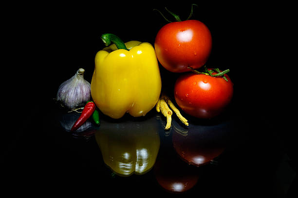 istock Vegetables on a board and a dark background tomatoes peppers 637066316