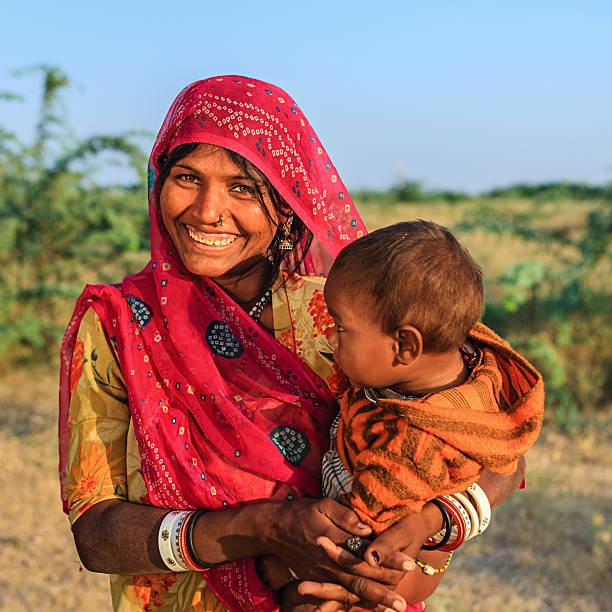 istock Young Indian woman holding her child 637067290