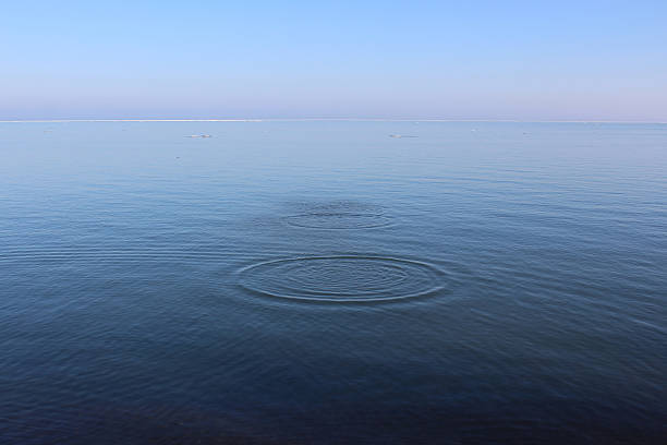 istock Clear water surface lake with concentric circles of water 637068252
