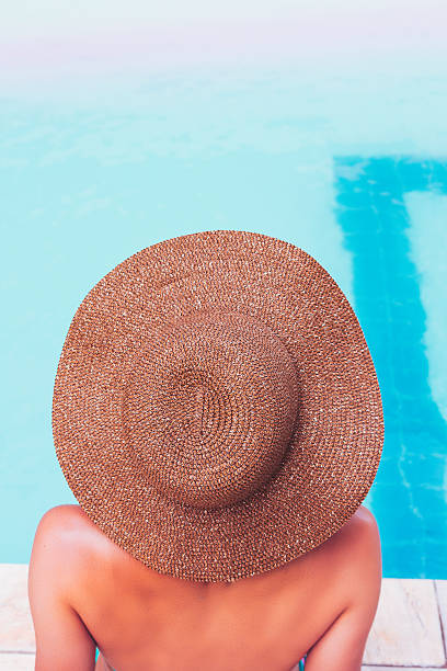 istock Young woman relaxing at the pool 637068812