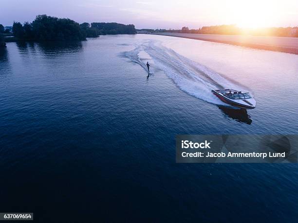 Man Water Skiiing On Lake Behind A Boat Stock Photo - Download Image Now - Nautical Vessel, Lake, Waterskiing