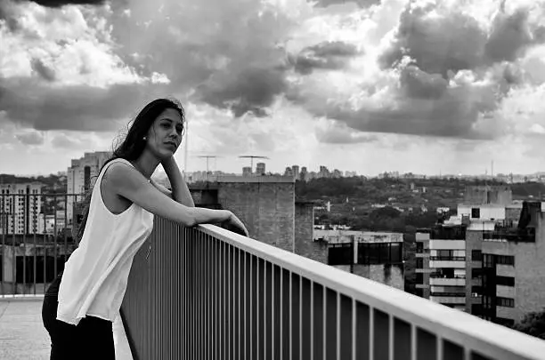 Girl on a terrace with a urban landscape in the background