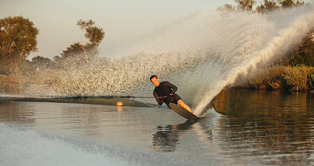 istock Wakeboarder surfing across the lake 637070550
