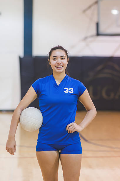 istock High school female volleyball player posing for the camera 637070638