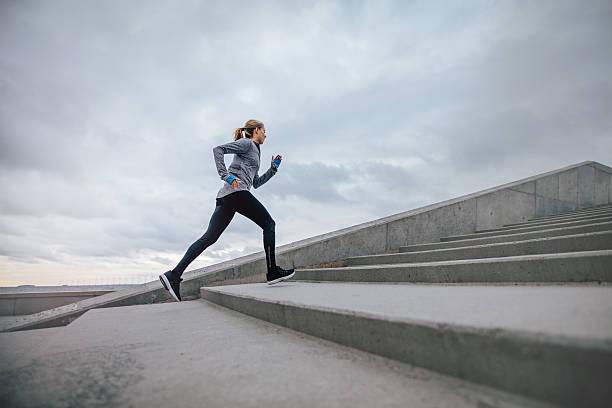 istock Woman running on steps outdoors 637070684