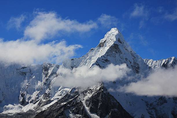istock Peak of Mt Ama Dablam surrounded by clouds 637071262