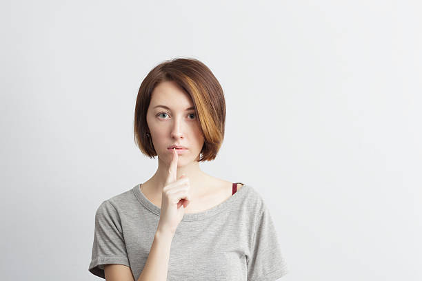 istock Beautiful, thin girl puts finger to her lips 637071266