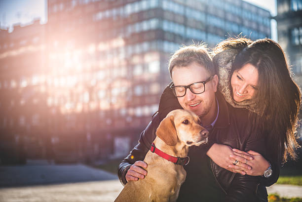 istock Happy couple with a dog 637071486