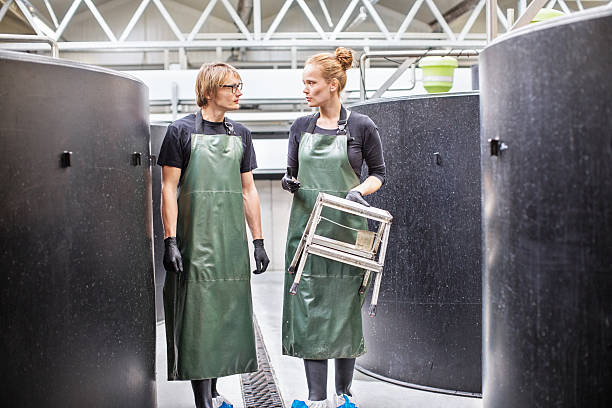 istock Man and woman working in fish farm 637071494