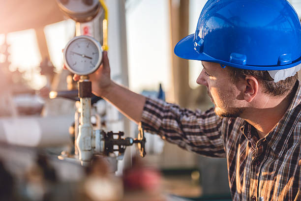 Man checking manometer Man checking manometer in natural gas factory fire inspection stock pictures, royalty-free photos & images