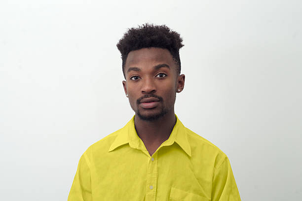 istock young man portrait in yellow shirt on white background 637077694
