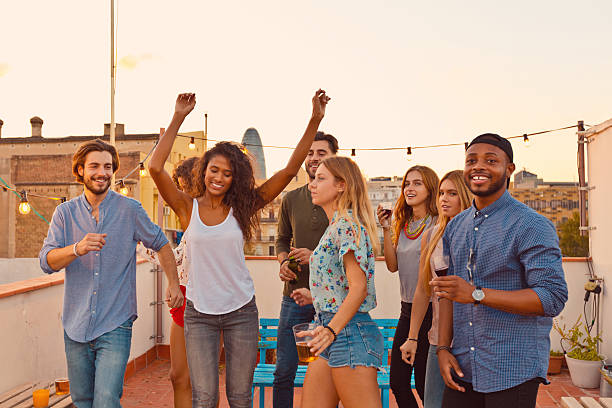 istock Happy friends dancing at the rooftop party 637078532