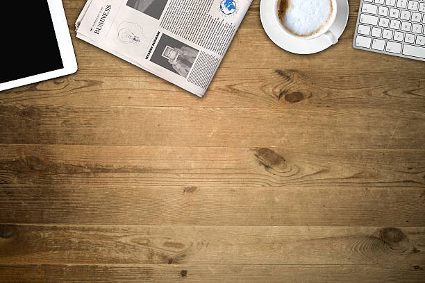 istock Daily newspaper and tablet pc on the wooden table. 637078564