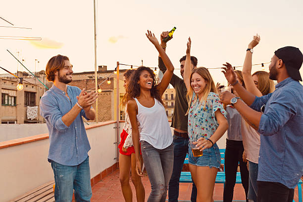 istock Happy friends dancing at the rooftop party 637078598