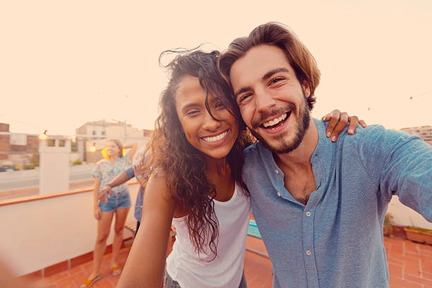 istock Happy young couple at the rooftop party 637078780