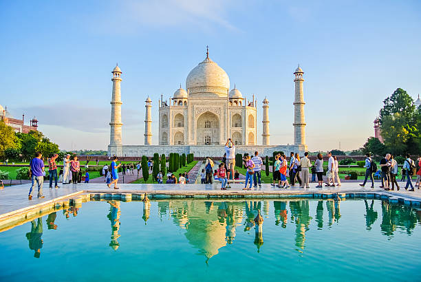 Tourists at Taj Mahal Agra, Uttar Pradesh, India - October 2, 2013: A group of tourists visits the Taj Mahal at sunrise in Agra. taj mahal stock pictures, royalty-free photos & images