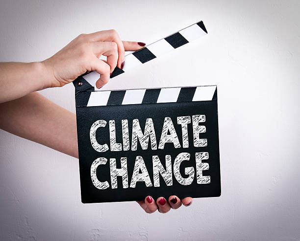 istock Climate change. Female hands holding movie clapper 637080220