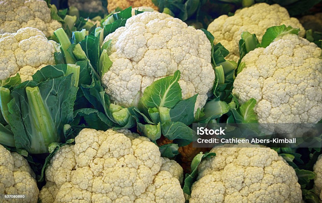 Cauliflower for sale at the farmer's Market Several heads of Cauliflower on display and for sale at the Farmer's Market. Agricultural Fair Stock Photo